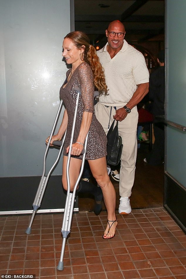 Wounded: His injured wife Lauren, 38, who was seen using crutches appeared to be in good spirits despite her troubling injury