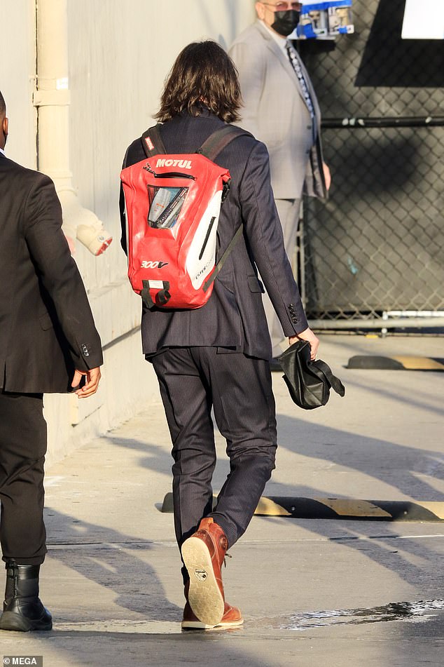 Taking his time: The Matrix star showed off his gracious side as he paused to sign memorabilia for adoring fans before heading into the studio in Hollywood