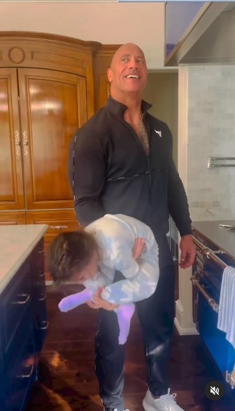 Dwayne Johnson uses his 5y/o daughter as weights while performing bicep curls