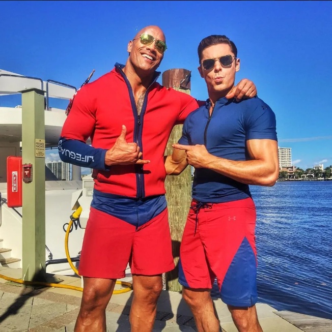 The Camera Suddenly Caught The Moment The Rock And Zac Efron Start Lifeguard Duty As Cameras Start Rolling On Baywatch Movie In Florida – The Rock